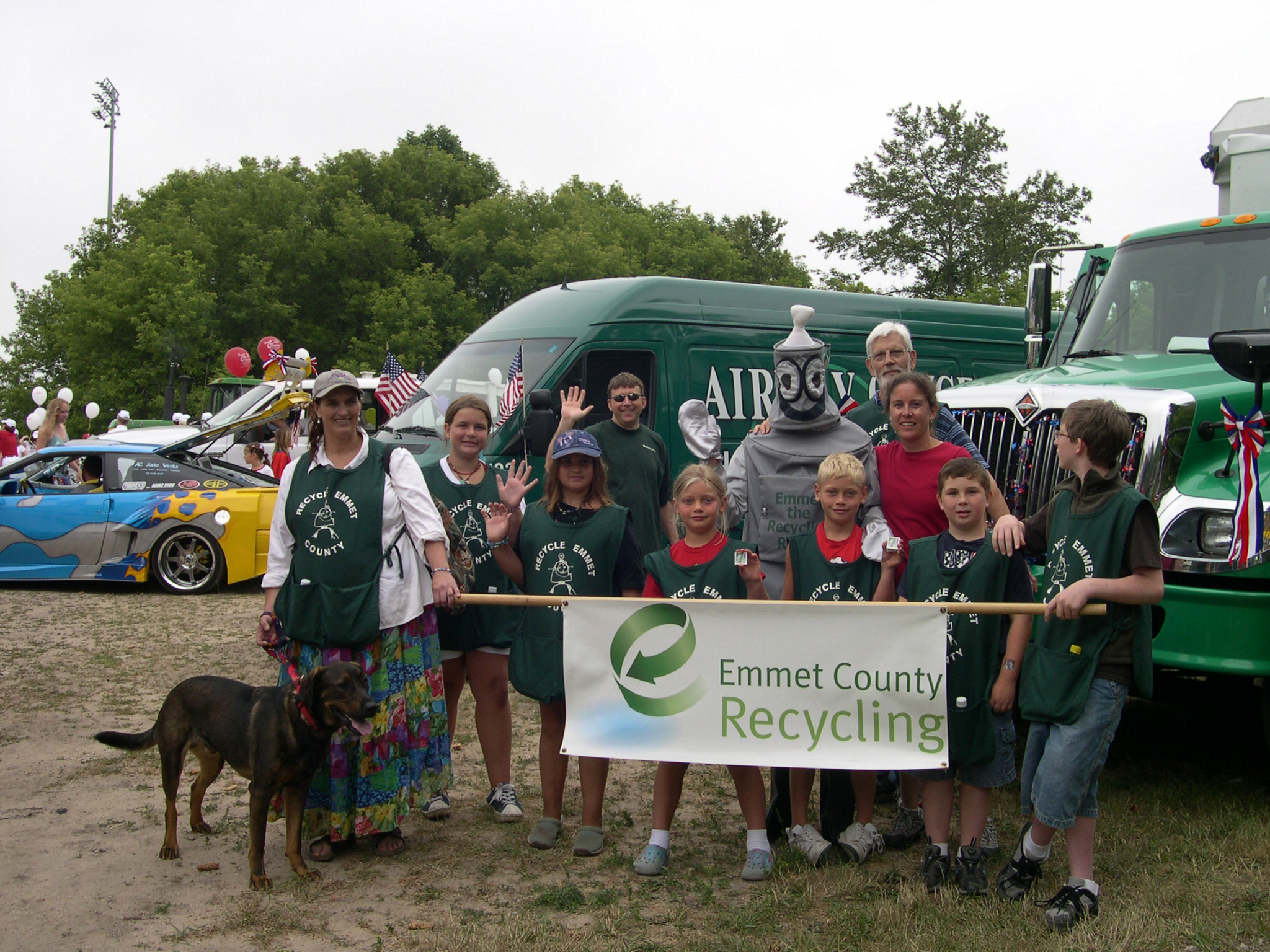 Emmet the Recycling Robot and a group of people holding a banner that says Emmet County Recycling.