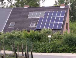 House with solar panels on about half of one side of roof.