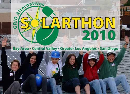 Six smiling people raising their arms, solar panels in background, Solarthon 2010 sign superimposed on photo.