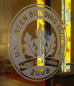 Leadership in Energy and Environmental Design for homes insignia etched into window glass on front of building.