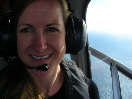 Kimberly flying with geologists in a helicopter to observe volcanic emissions and study how they may be impacting glaciers in New Zealand.