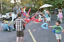 Kids play with balloon animals at the farmer's market.