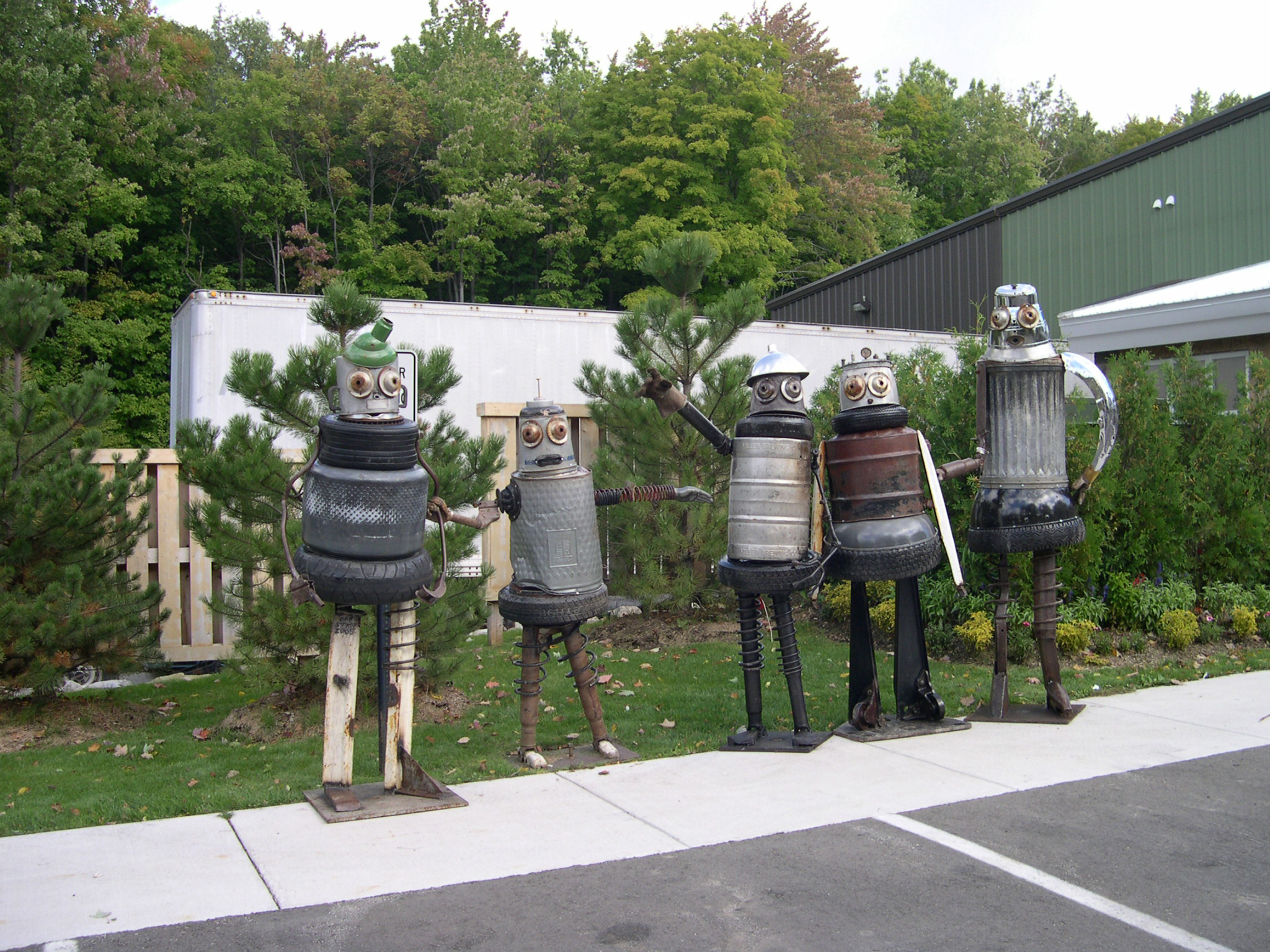 A row of five robot sculptures.