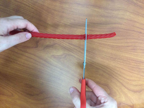 photo of scissors cutting red licorice into short sections