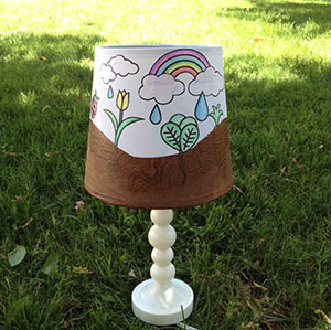 a decorated lampshade in the grass.