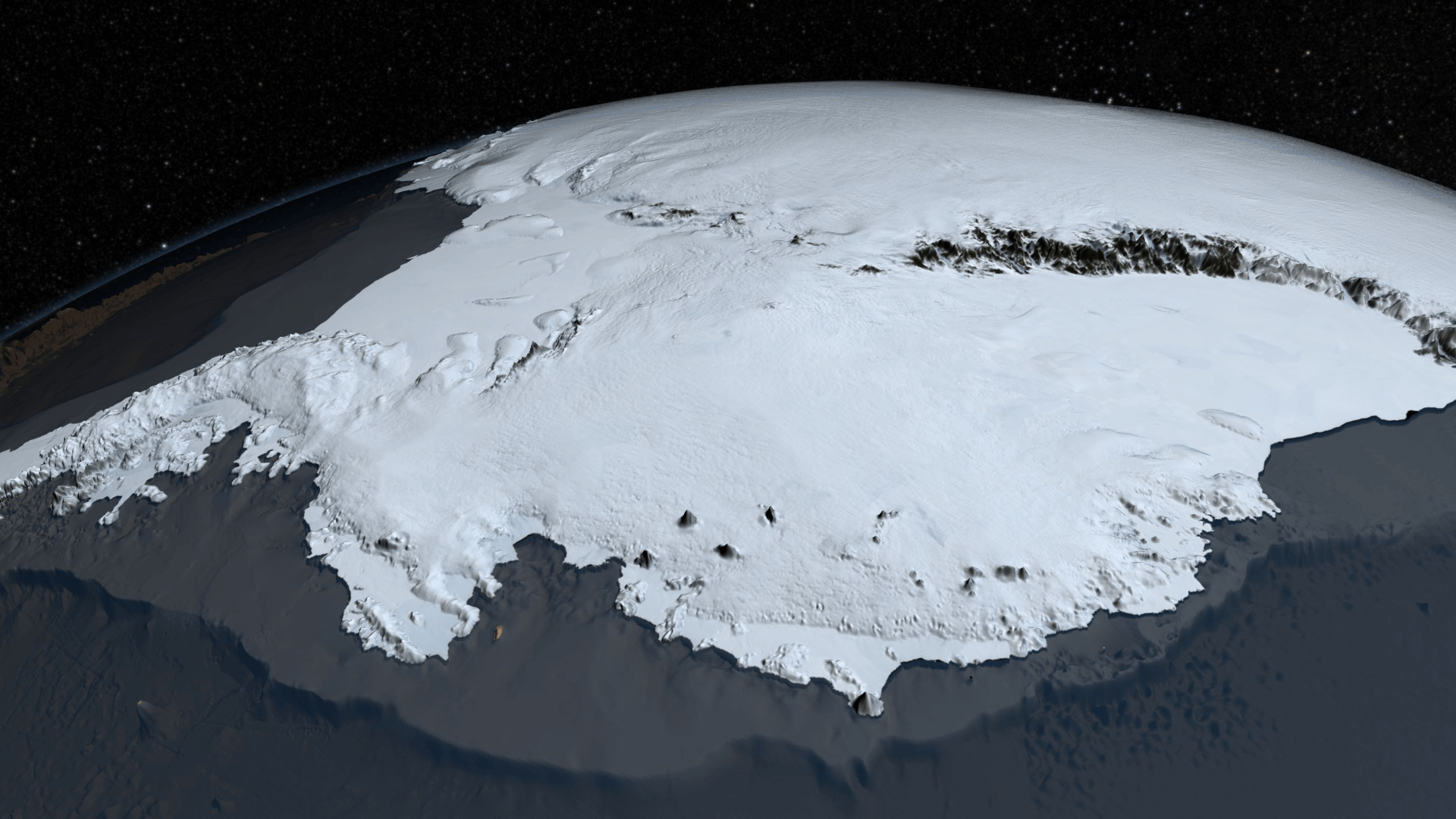 A textured view of part of the Antarctica continent colored white with a gray and black background. The edges of the continent are higher than the gray background, which represents the ocean floor. The continent is curved to follow the curve of Earth, but the visible parts use light gray shadows to show shading of the high mountain edges to make it look 3D.
