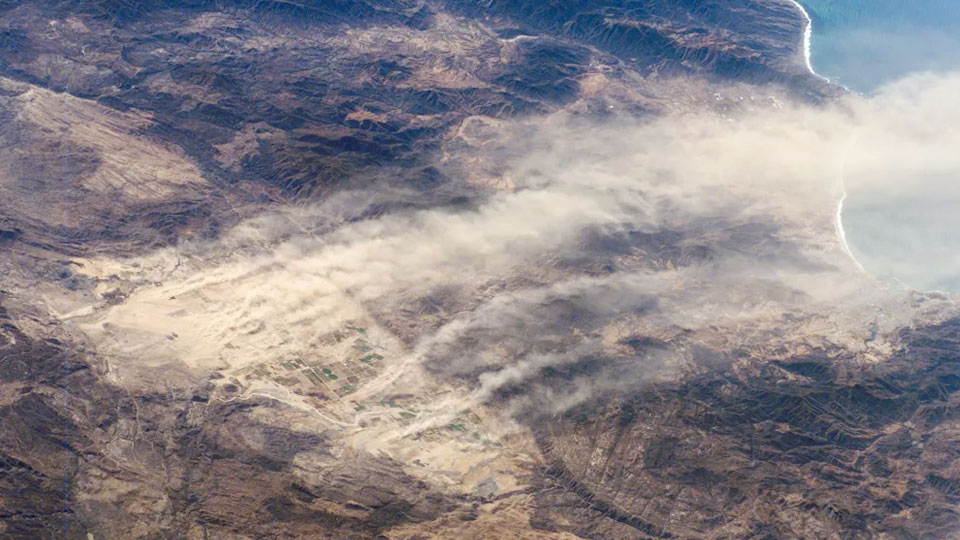 An Image of Baja, CA, taken from the International Space Station depicts strong winds blowing dust into the Pacific Ocean.