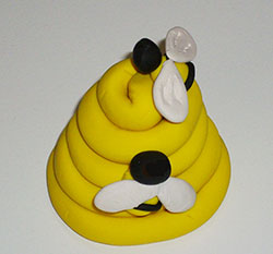 Photo of polymer clay beehive with little bees.
