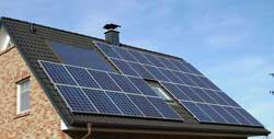 Photo of house with solar panels on roof.